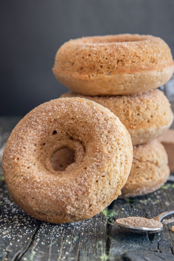 Three donuts stacked with one leaning.