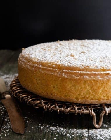 sponge cake dusted with powdered sugar on a wire rack