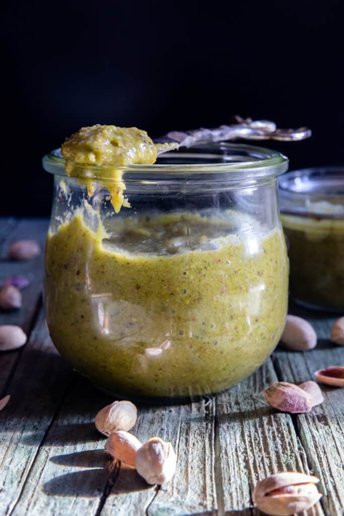 Cream in a jar and some on a knife.