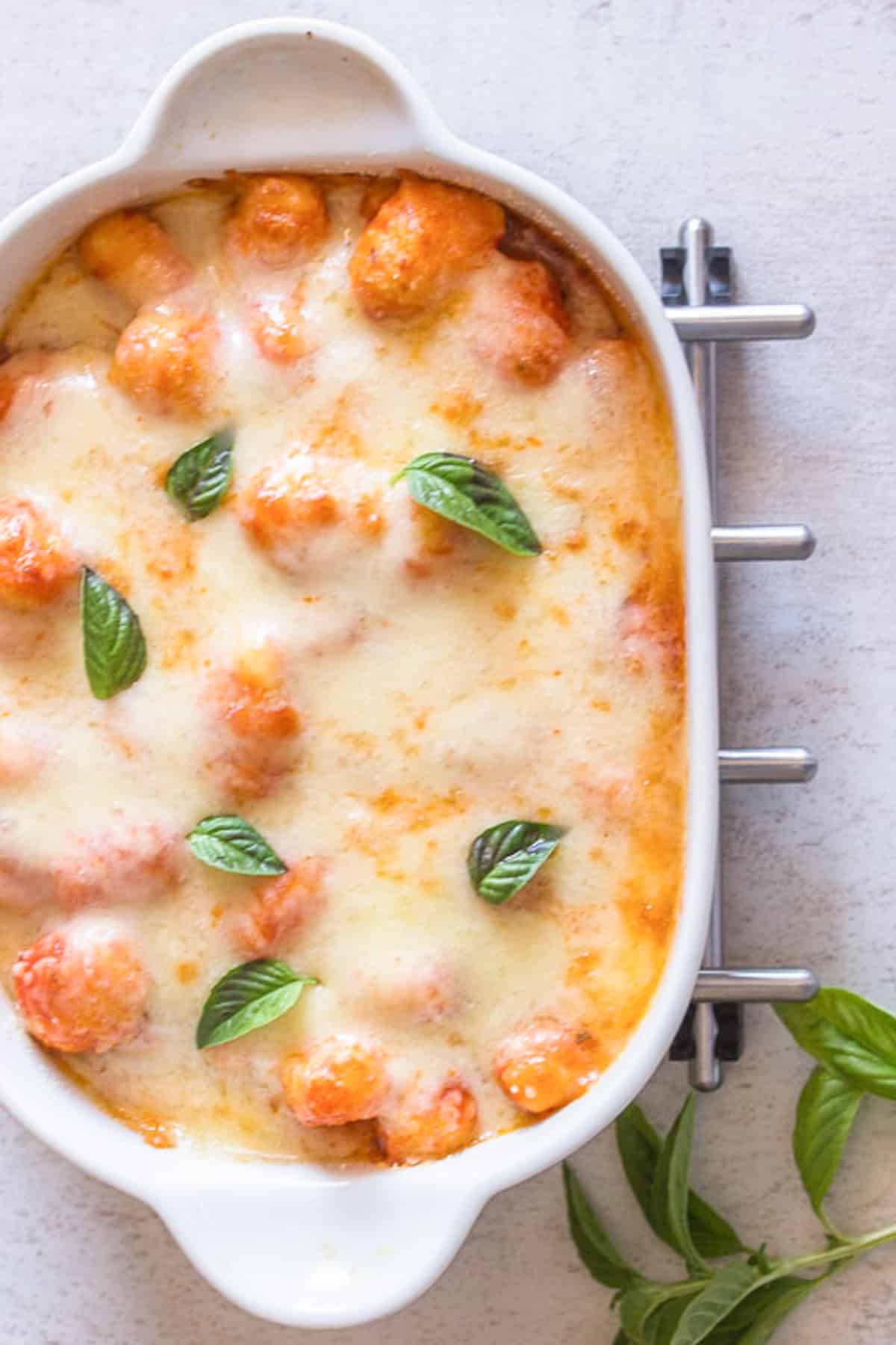 Baked gnocchi in a white baking dish.