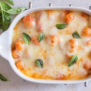 Baked gnocchi in a white baking dish.