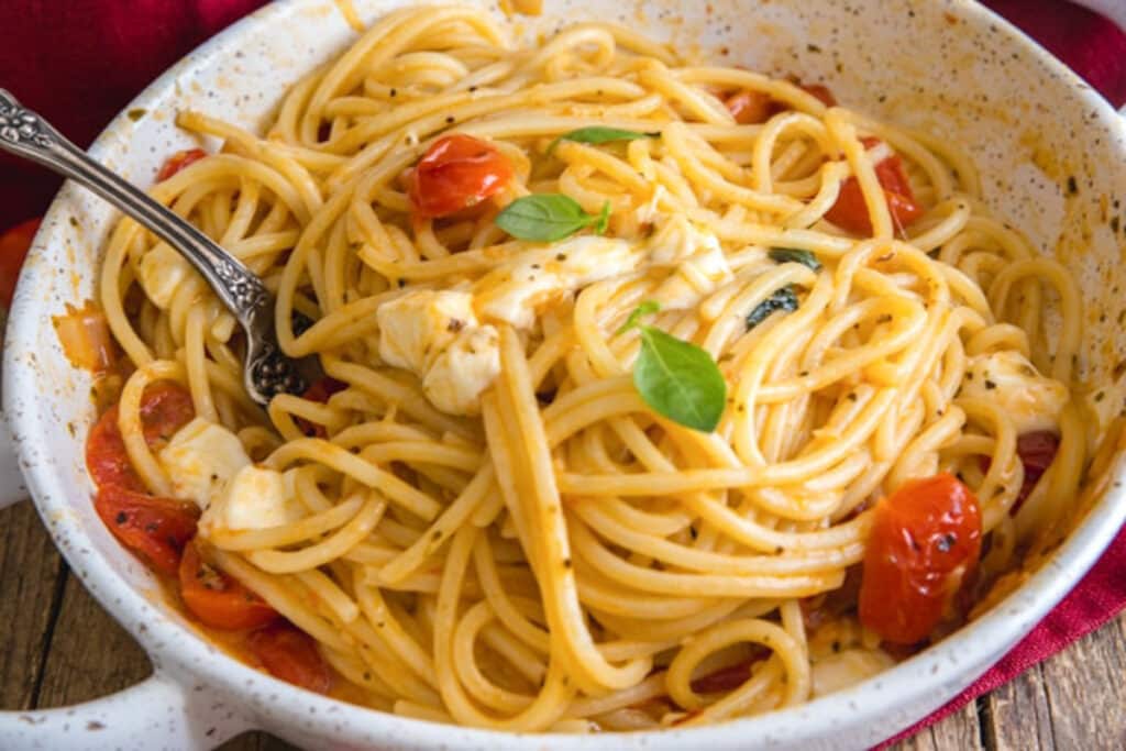 Caprese pasta in a white pan.