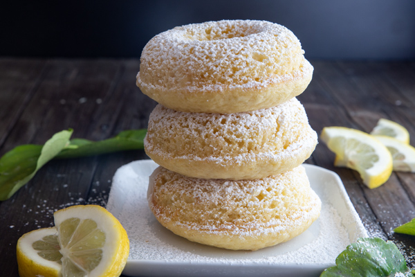 3 donuts stacked and sprinkled with powdered sugar