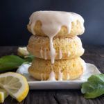 3 lemon donuts stacked with lemon glaze dripping down