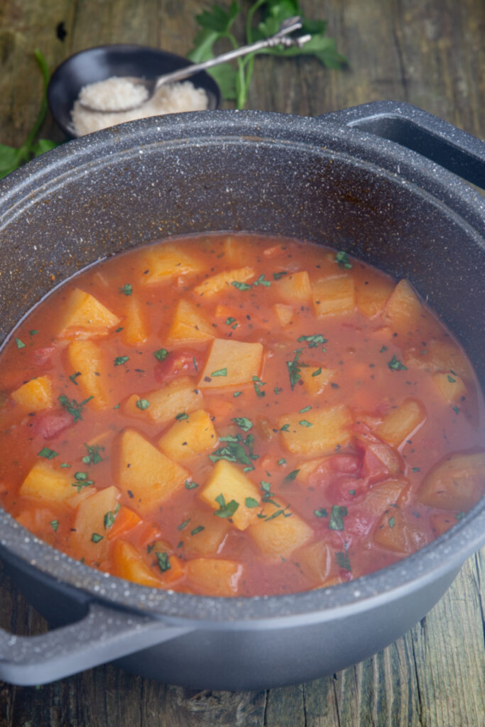 Potato soup in a black pot.