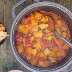 Potato soup in a black pot.