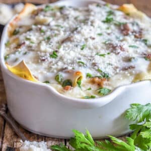 White lasagna in a white baking dish.