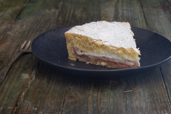 a slice of cake on a black plate