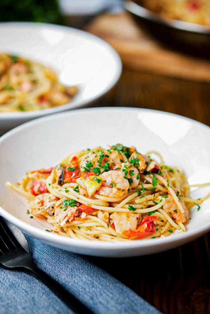 Pasta with seafood on two plates.