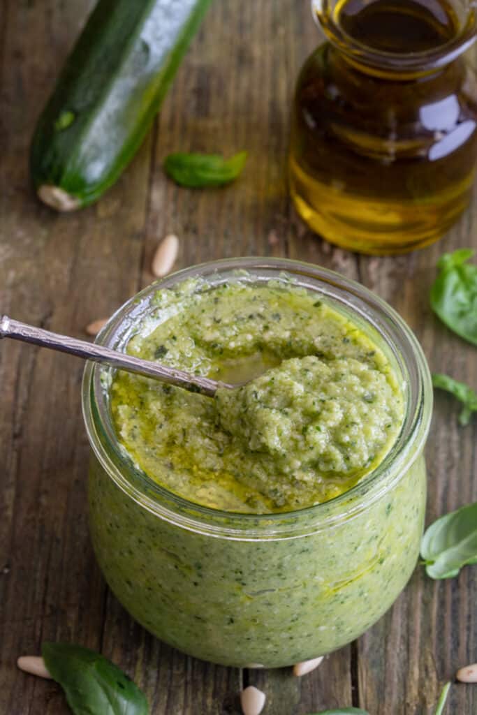 Zucchini pesto in a glass jar.