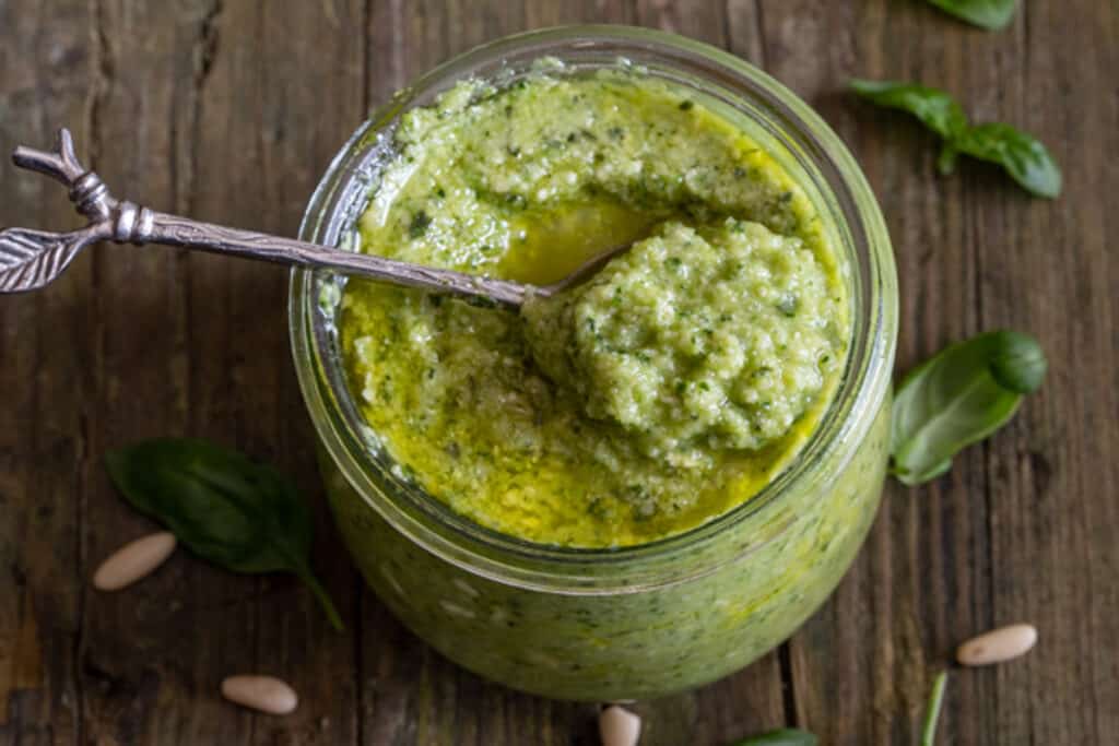 Zucchini pesto in a glass jar.