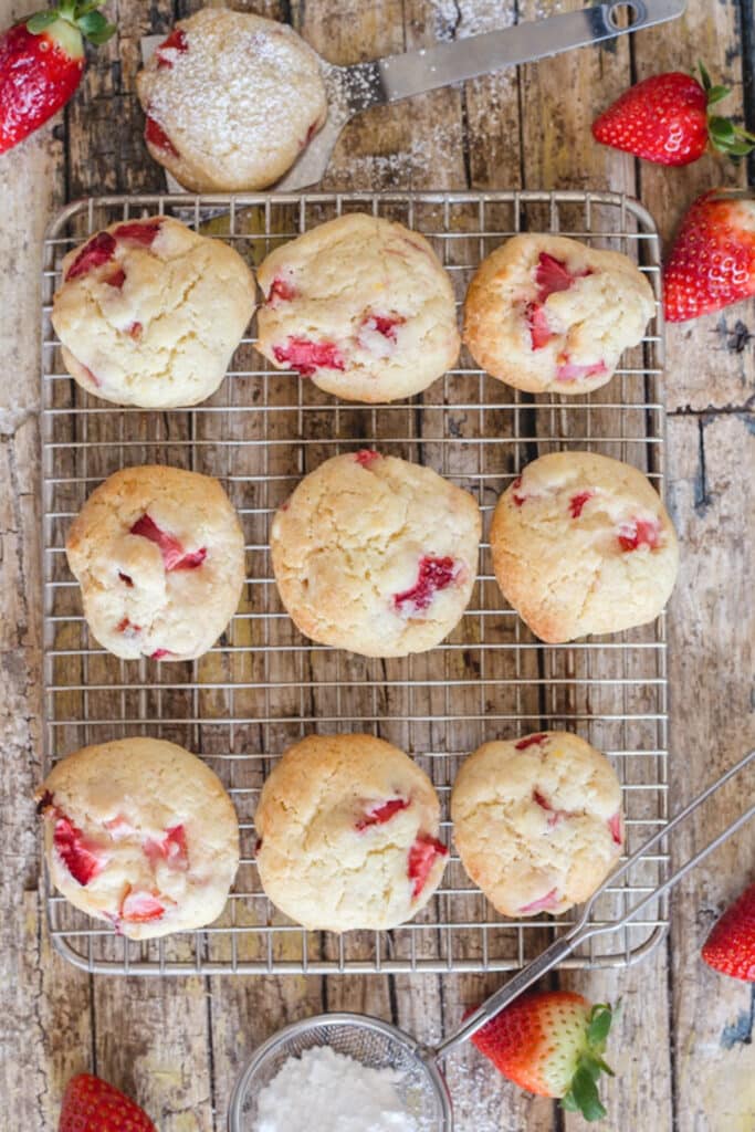 Strawberry cookies on a wire rack.