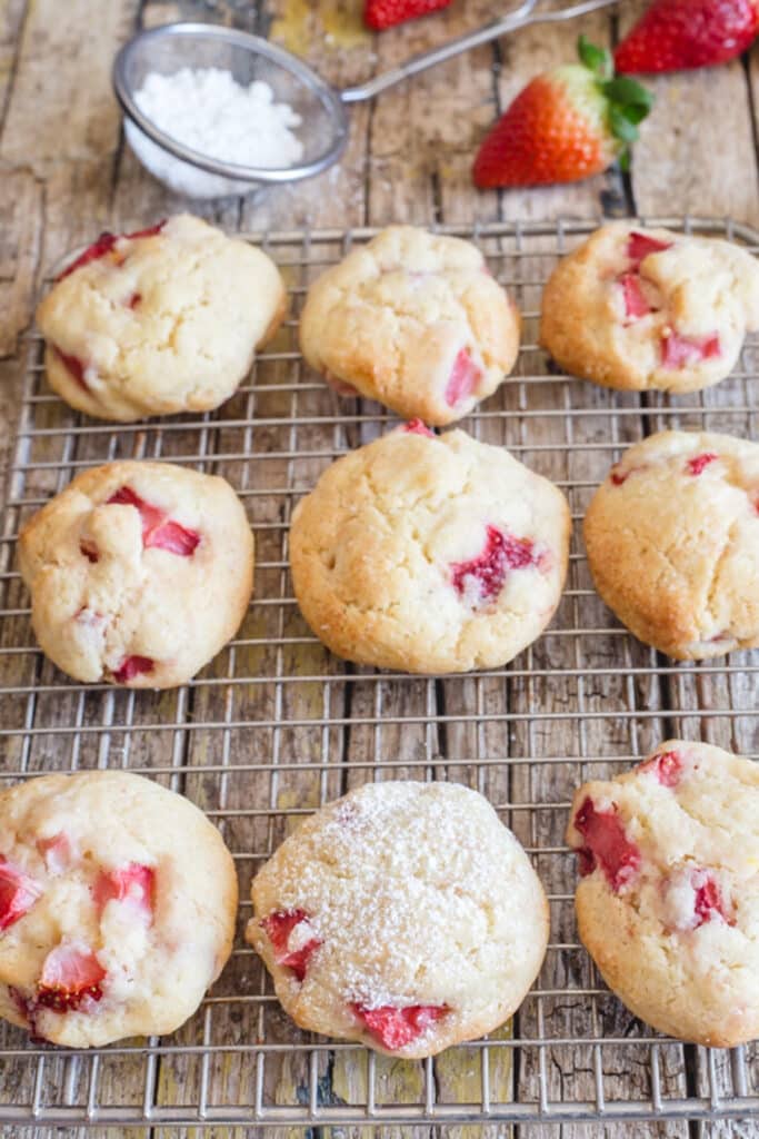 Strawberry cookies on a wire rack.