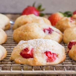 Strawberry cookies on a wire rack.