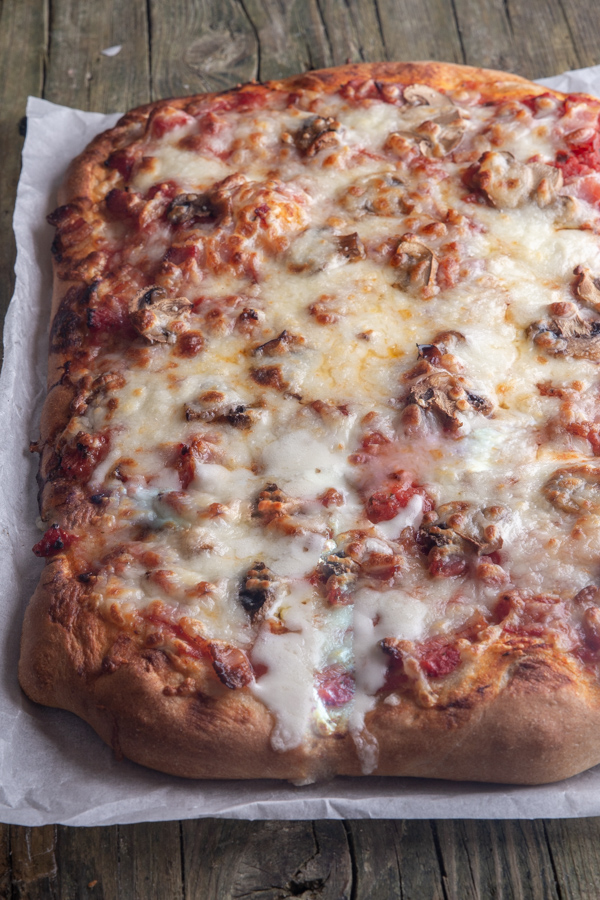 whole pizza on a piece of parchment paper.