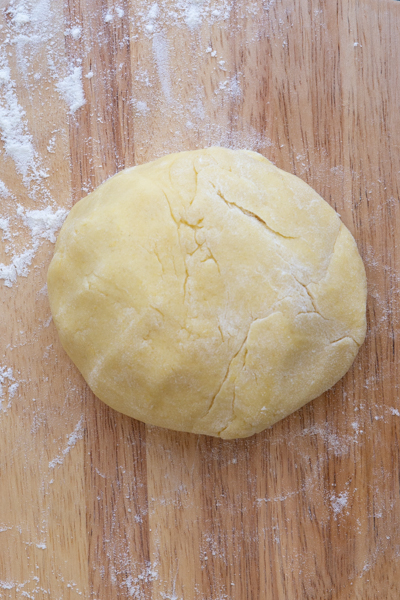 Dough rolled into a ball on a board to be chilled.