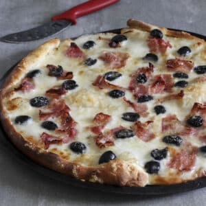 Pizza in a black pan.