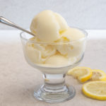 Lemon ice cream in a glass bowl.