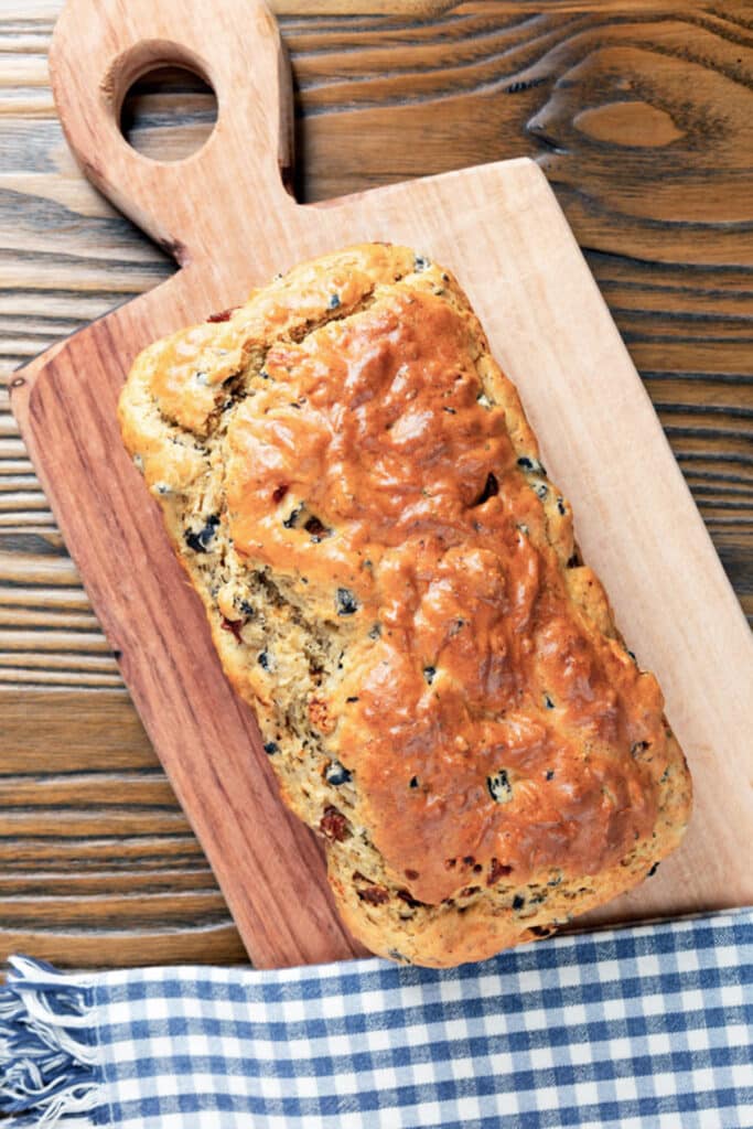 A loaf of bread on a wooden board.