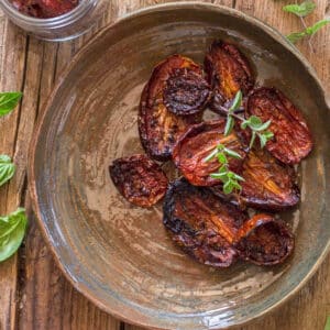 Oven dried tomatoes in a brown plate.