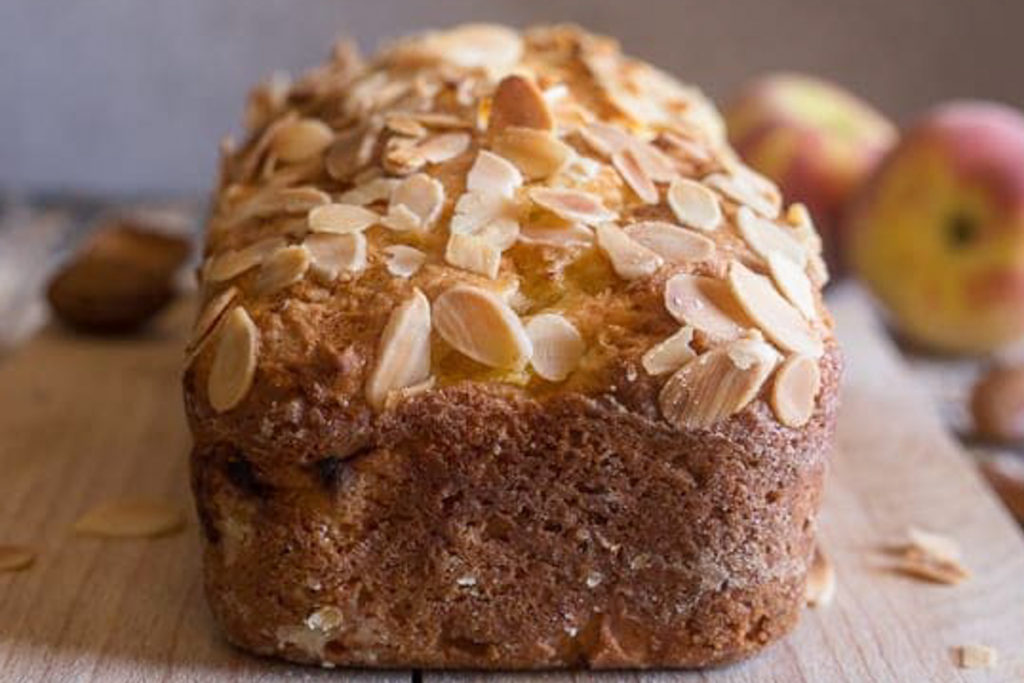 Baked peach bread on a wooden board.