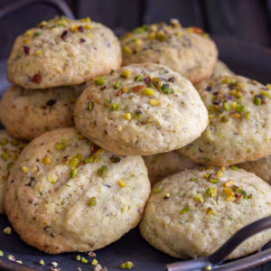 Pistachio cookies on a black tray.