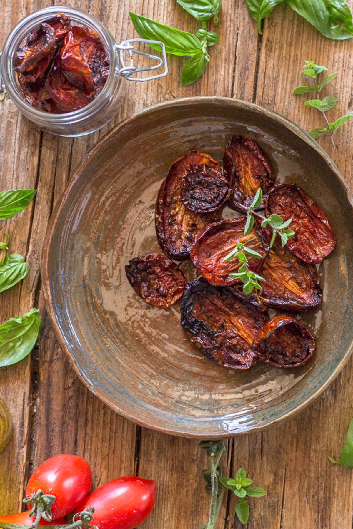 Sun dried tomatoes in a brown dish and a glass jar.