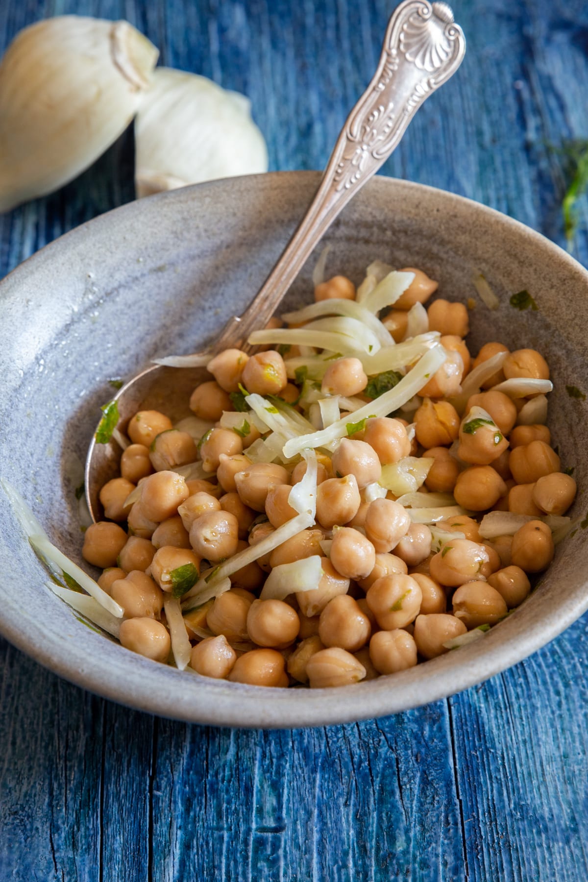 Chickpea salad in a blue bowl.