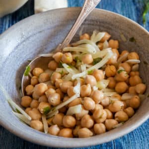 Chickpea salad in a blue bowl.