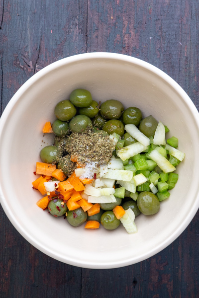 All the ingredients for the salad in a white bowl.