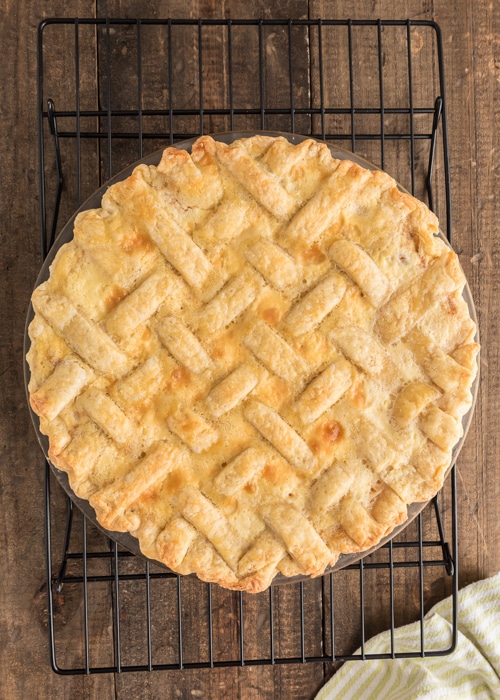 The baked pie on a wire rack.