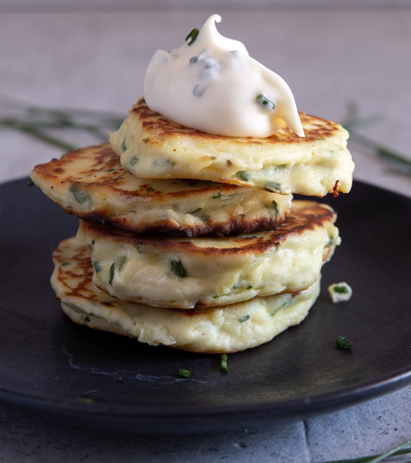 4 ricotta fritters stacked with a dollop of chive mayo.