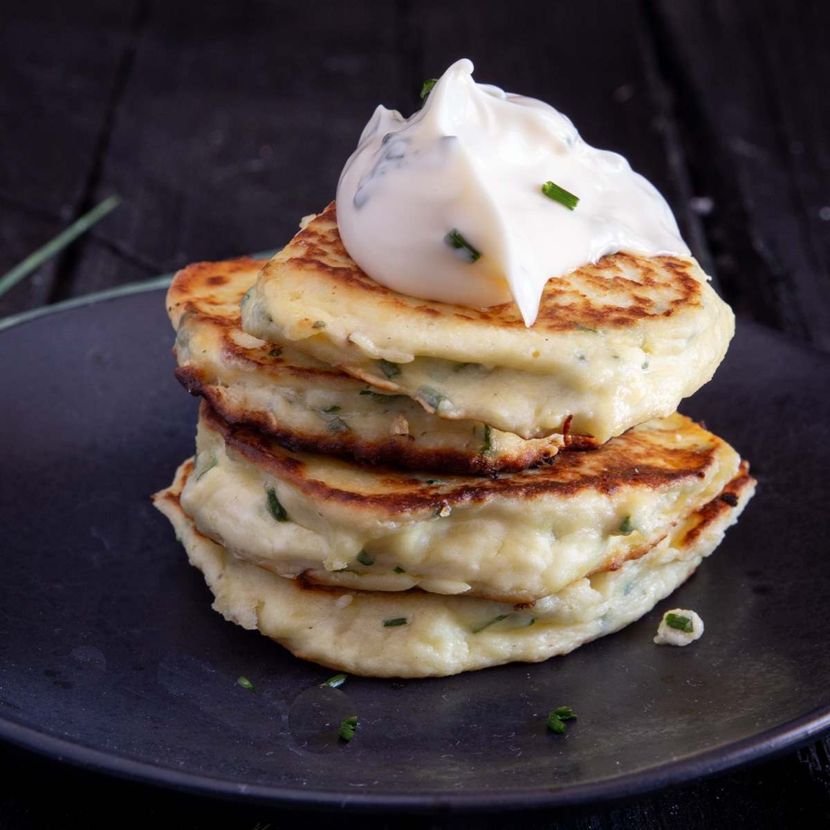 4 ricotta fritters stacked with a dollop of chive mayo.