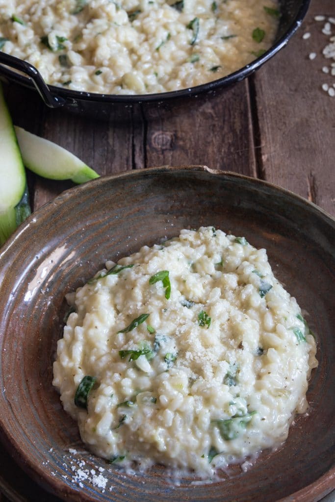 Zucchini Risotto in a brown plate.