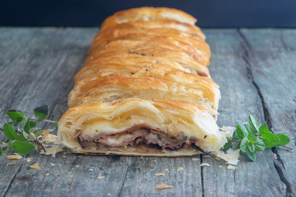 Eggplant strudel on a blue board.