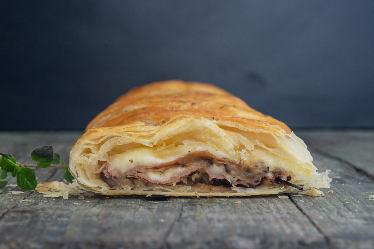 Strudel sliced on a blue board.