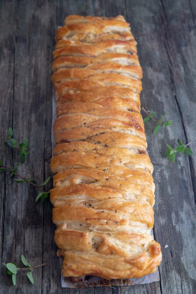 Eggplant strudel on a blue board.