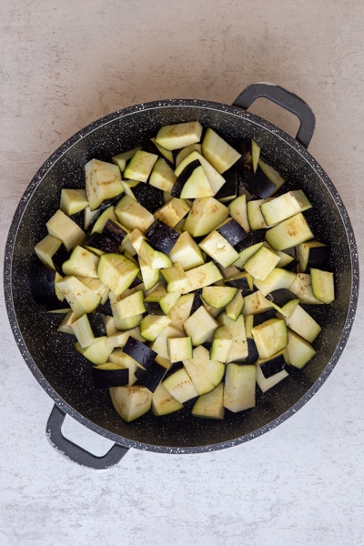 Eggplant in a pan before cooking.