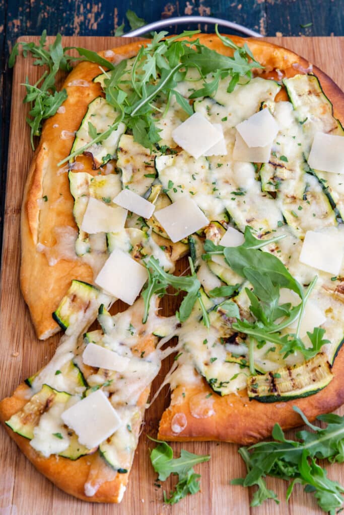 Zucchini pizza with a slice cut.