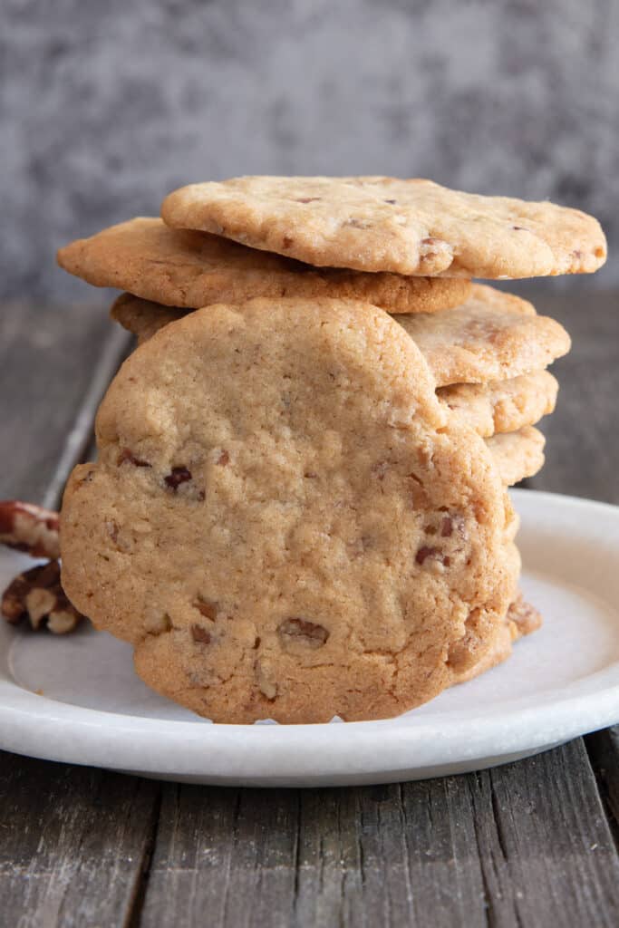 Stacked cookies with one leaning against them.