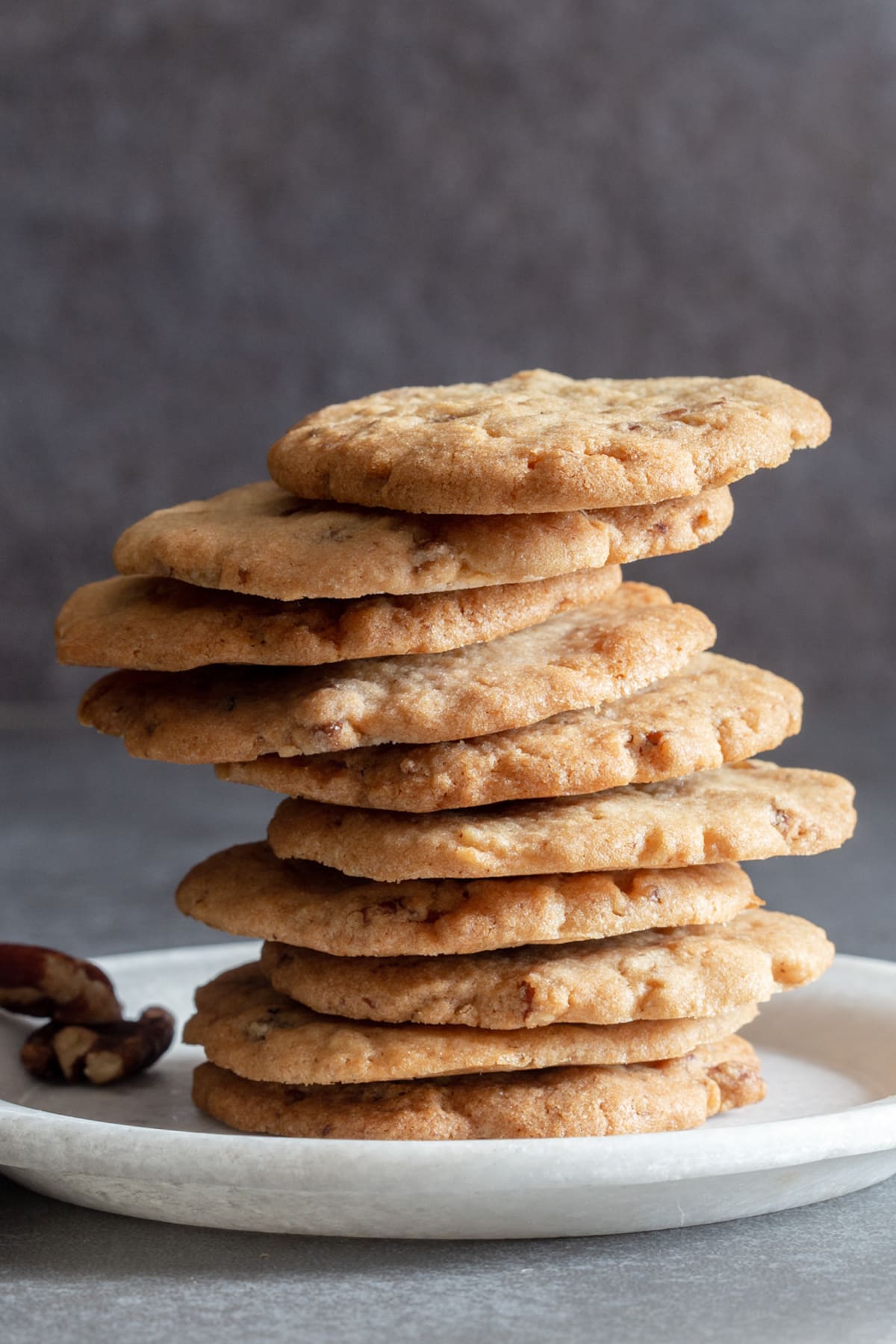 Cookies stacked on a white plate.