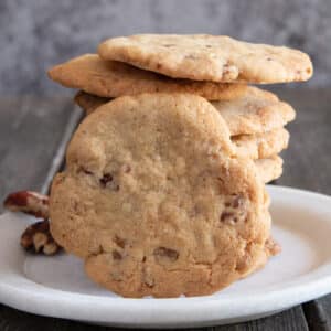 Stacked cookies with one leaning against them.