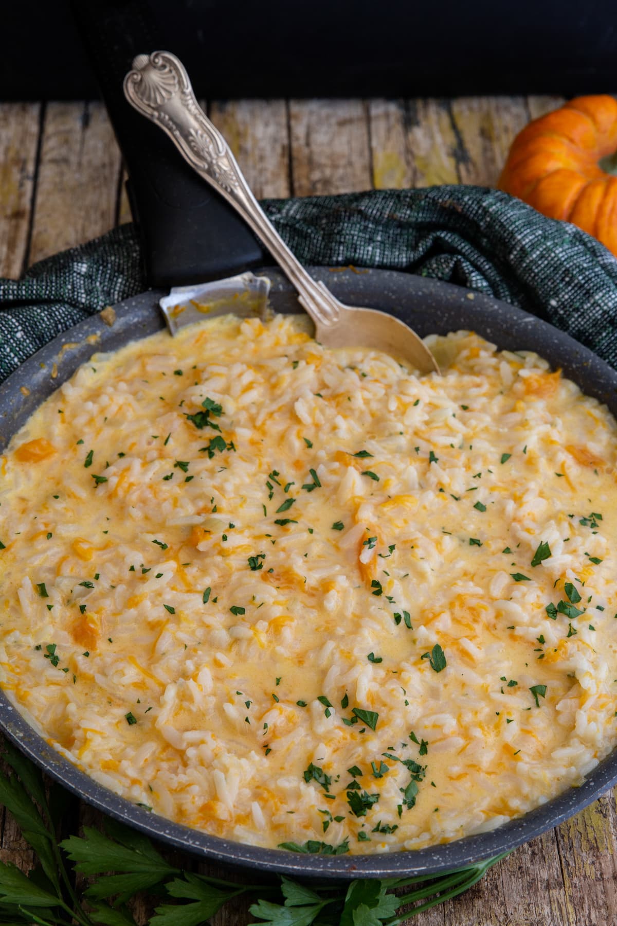 Pumpkin risotto in a black frying pan.