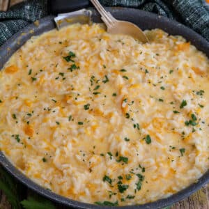 Pumpkin risotto in a black frying pan.