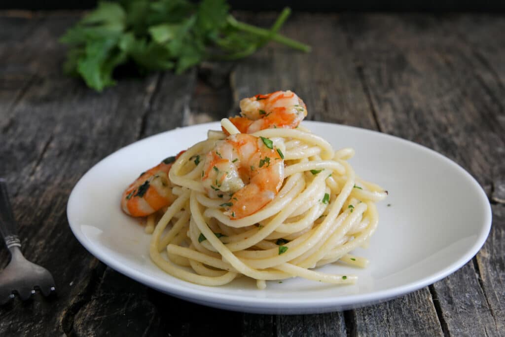 Shrimp pasta on a white plate.