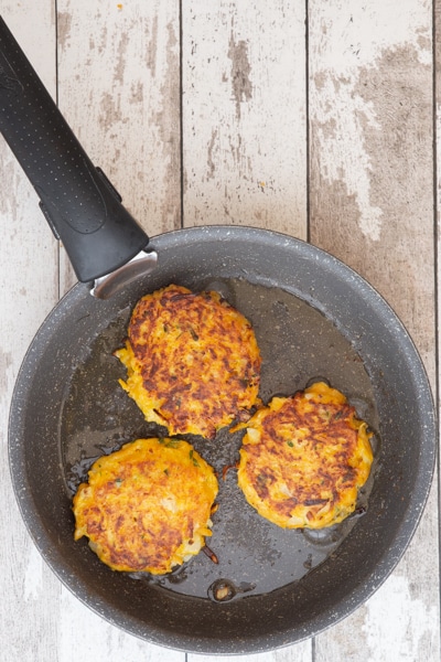 Pumpkin fritter cooked in a frying pan.