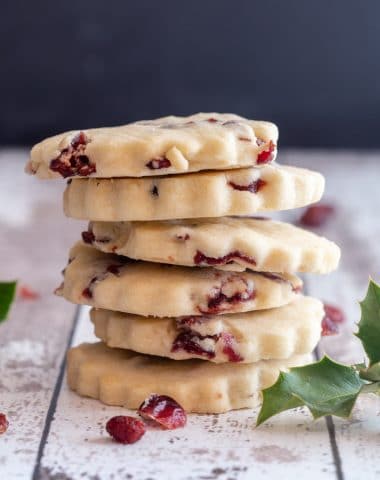 6 cranberry shortbread cookies stacked.