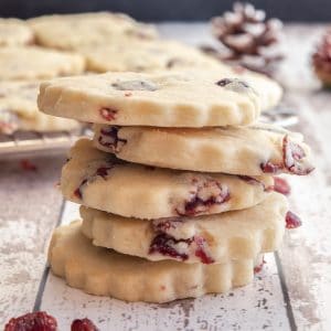 6 cranberry shortbread cookies stacked.