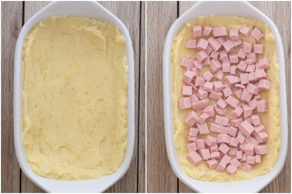 Placing some of the mashed potato mixture in a white baking dish with cubed ham on top.