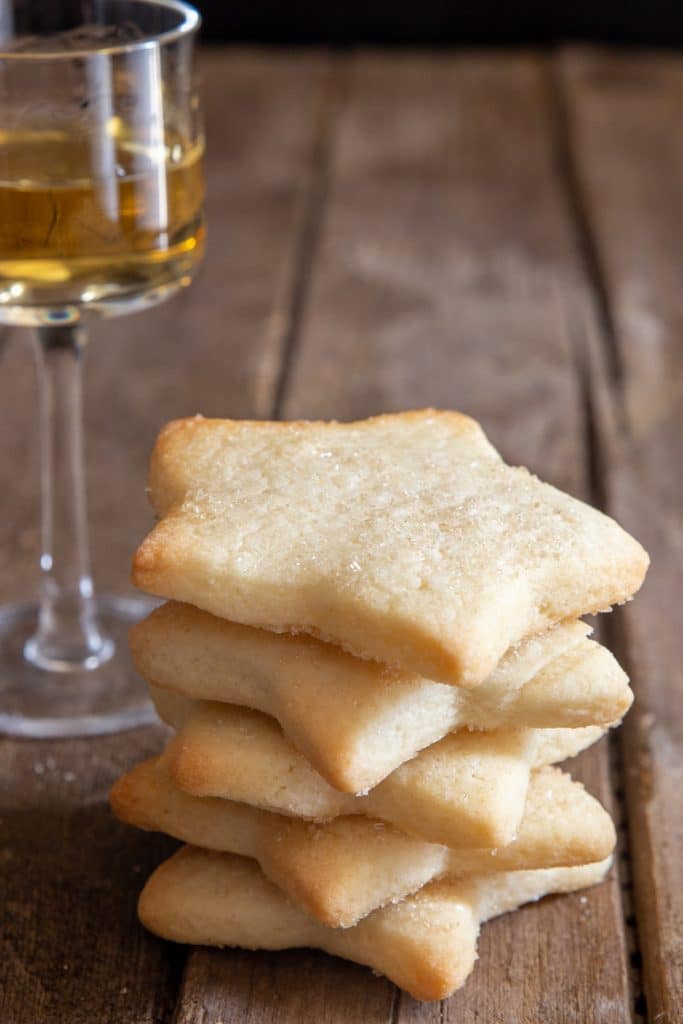 5 cookies stacked with a glass of rum.